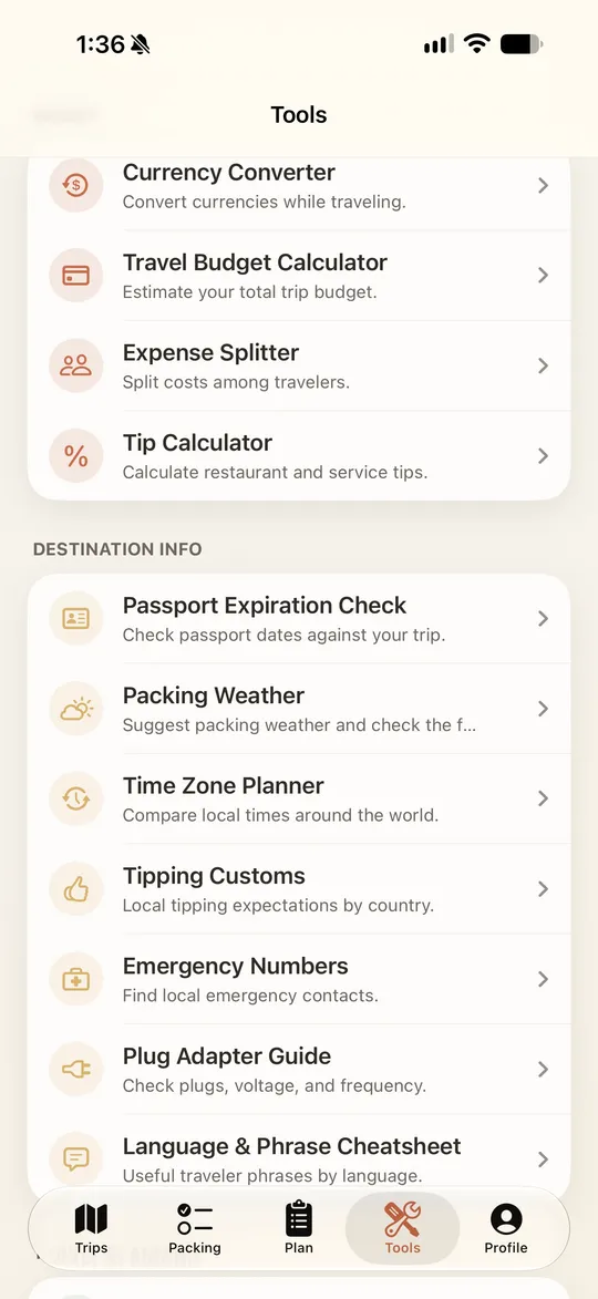 PackBetter Tools screen with a currency converter, travel budget calculator, expense splitter, tip calculator, and destination tools for passport dates, packing weather, time zones, tipping customs, emergency numbers, plug adapters, and phrases.